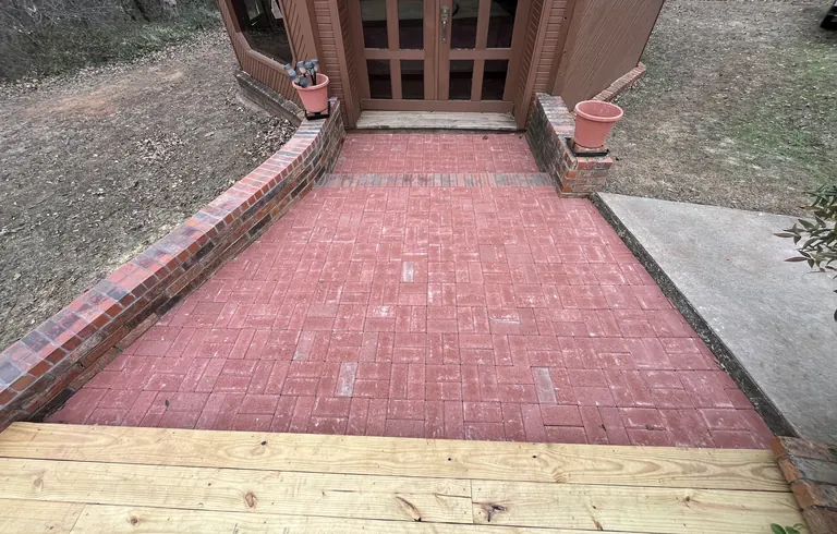 Red brick paver walkway with brick border walls at a gazebo entry