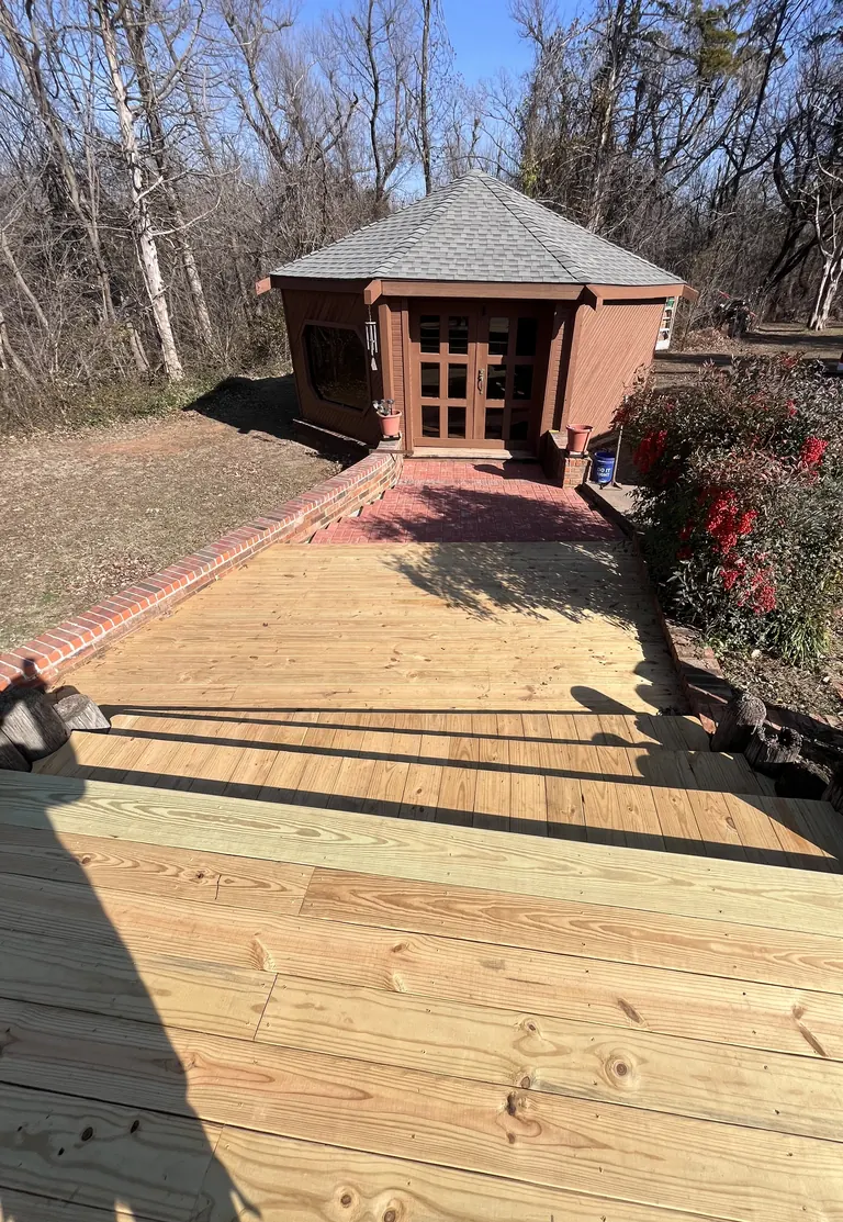 Red brick paver walkway with brick edging leading to a backyard gazebo