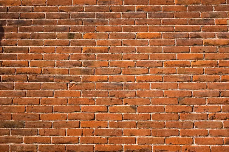 Red brick wall with straight, even mortar joints