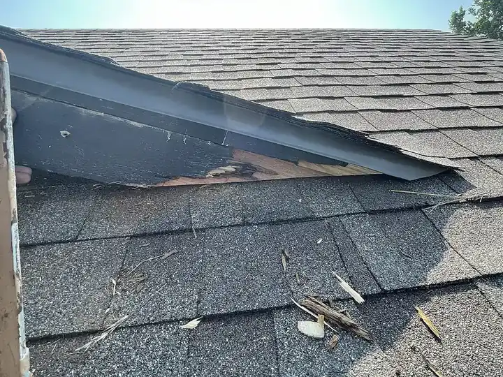 Damaged fascia and roof edge before repair