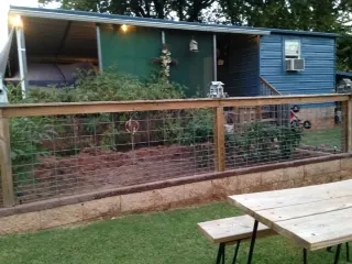 Garden fence with wire panels and wood posts