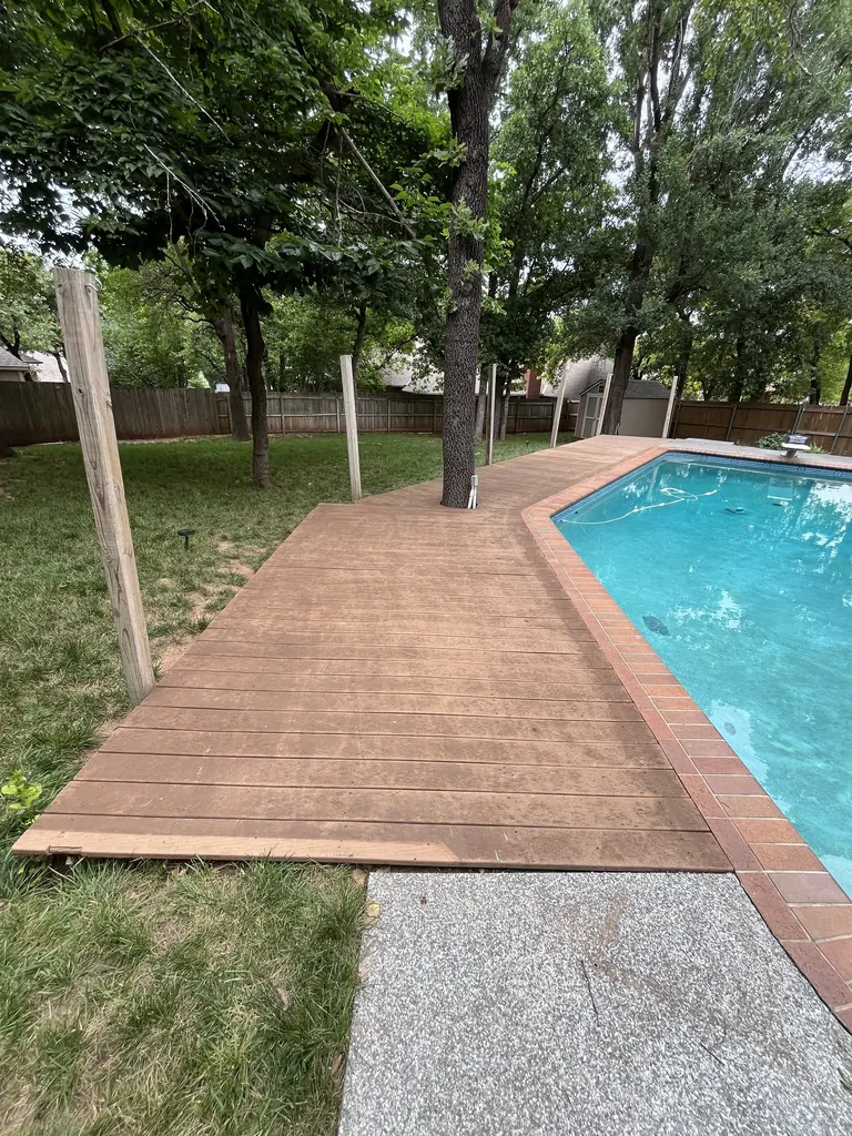 Stained concrete pool deck with a brick border