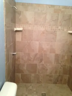 Tiled shower walls with corner shelves