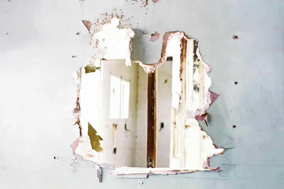 Hole in a sheetrock wall before repair